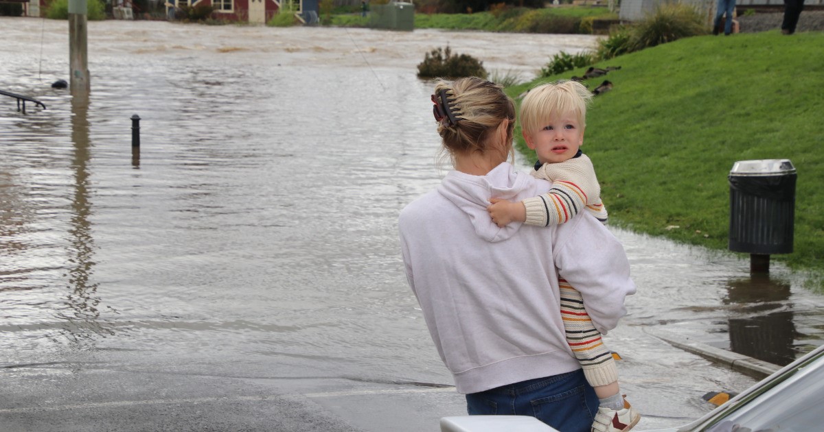 A mother and a child caught up in flood waters in northern Tasmania.