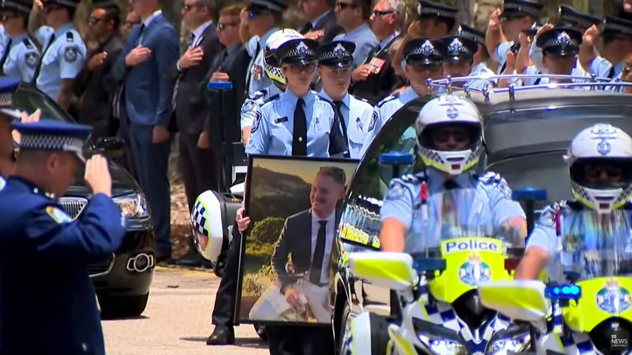 An officer carried a large framed photo of Matthew.