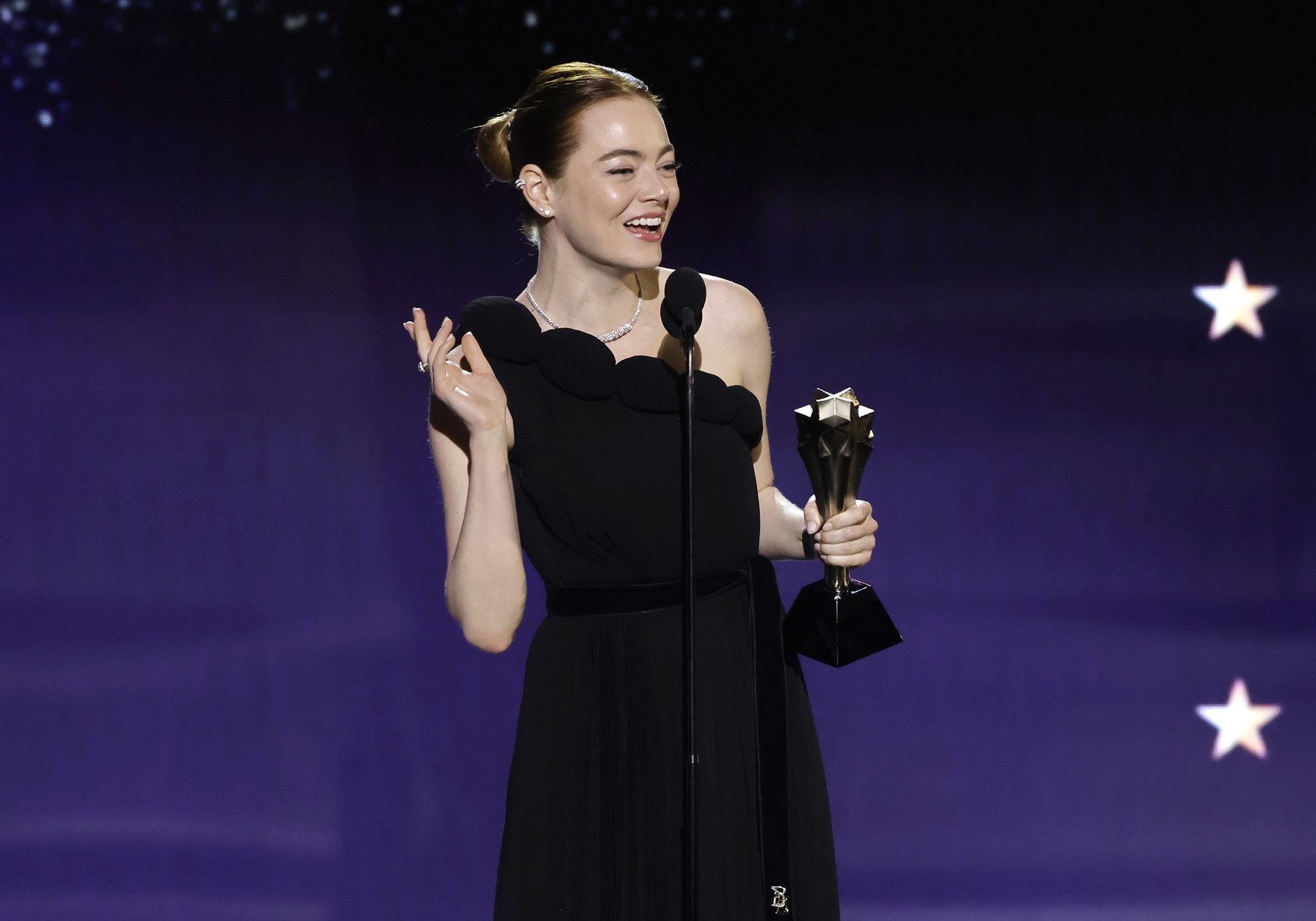 Emma stone holding an award. 