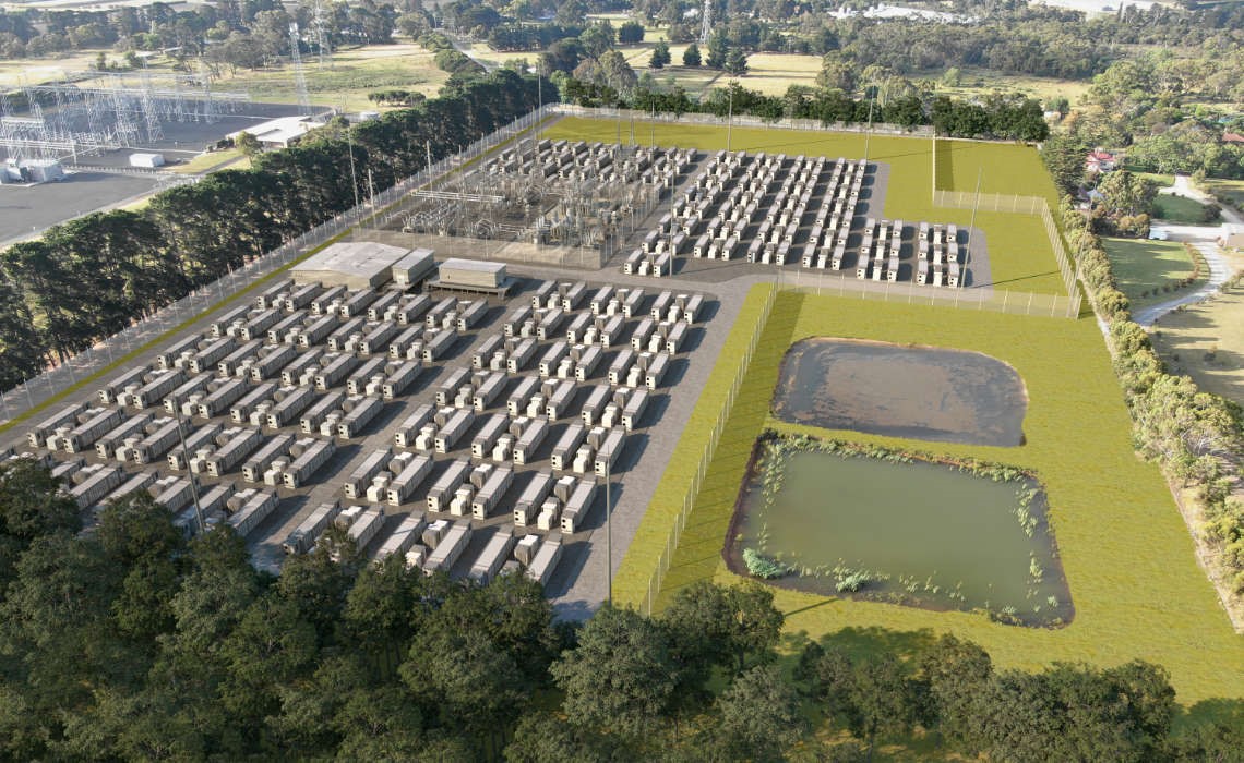 A bird's eye view of a several white long commercial storage batteries surrounded by green grass.