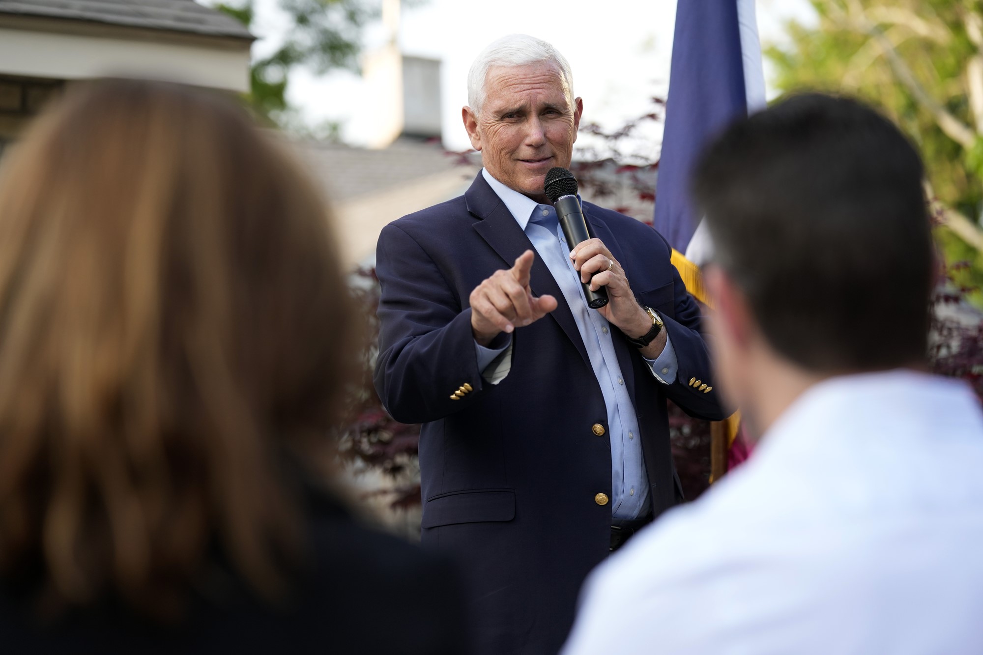 Former Vice President Mike Pence speaks into a microphone