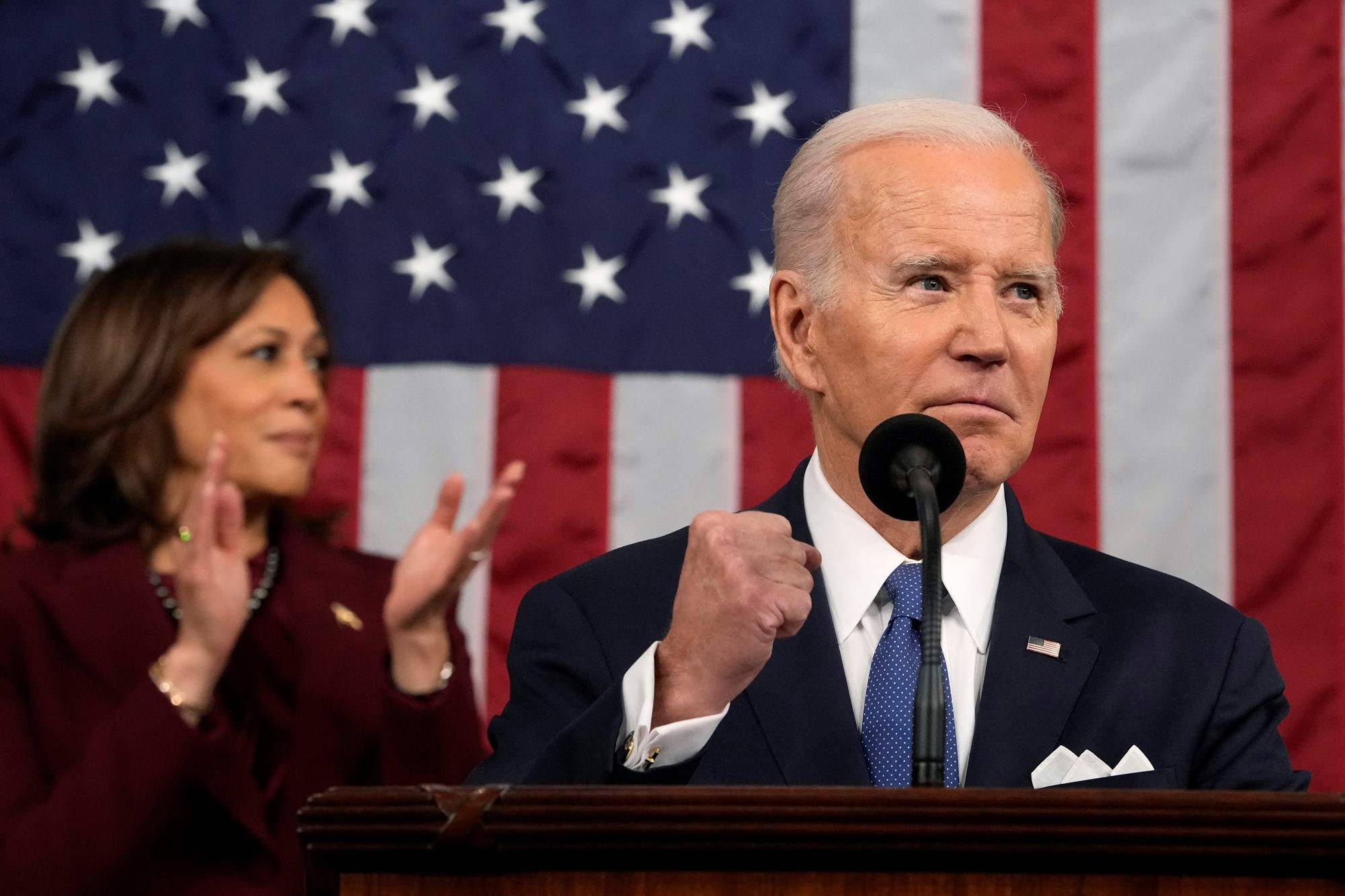 Biden clenches his fist as Kamala claps behind him,