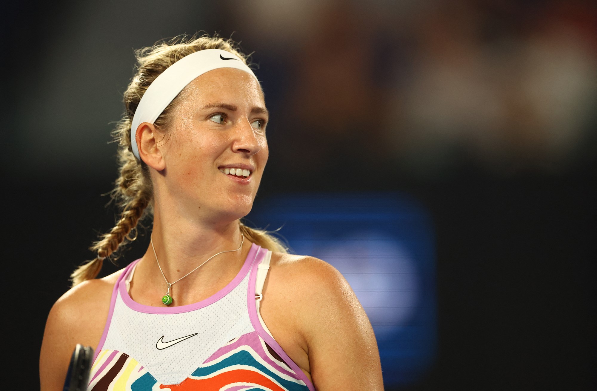 A female tennis player smiles.