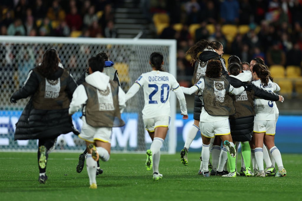 Philippines players run to celebrate with each other after a Women's World Cup game.