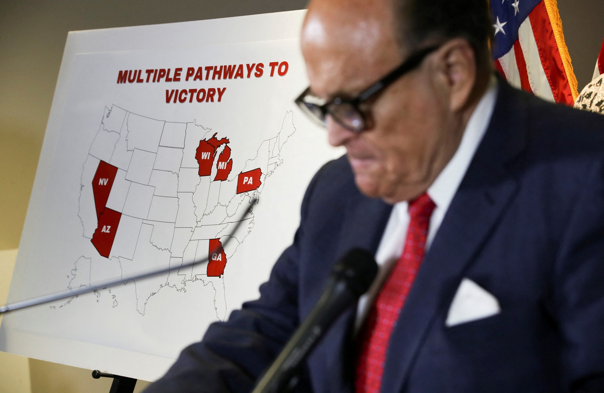 Former New York City Mayor Rudy Giuliani, personal attorney to U.S. President Donald Trump, stands in front of a map of election swing states