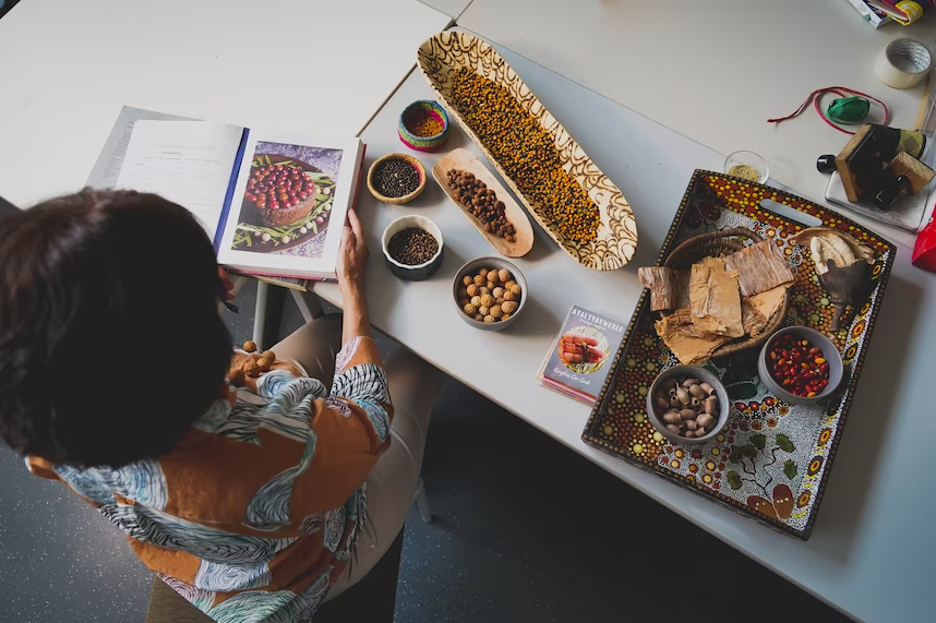 Rayleen Brown with a cookbook and ingredients.