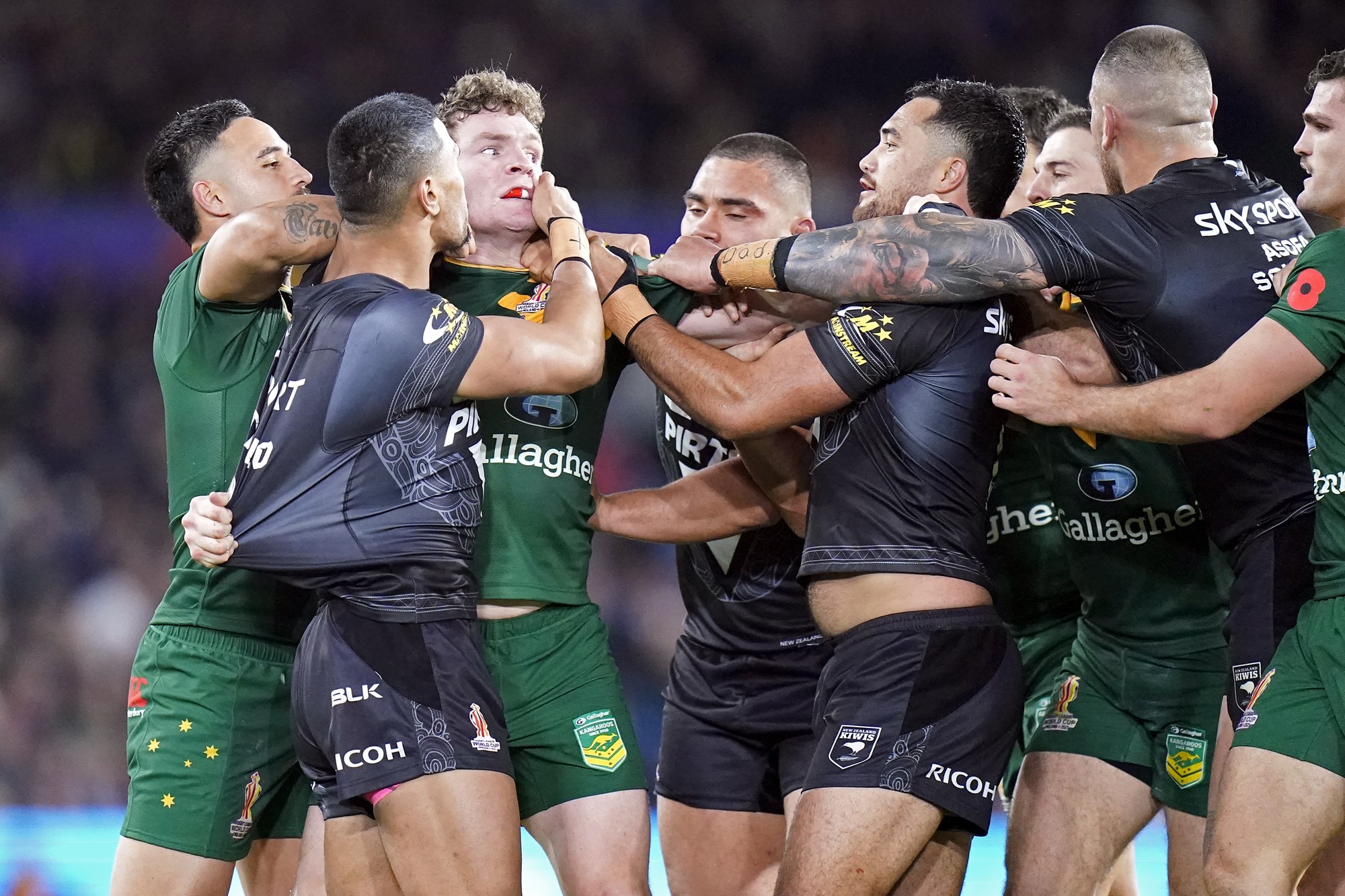 Kangaroos and Kiwis players fight during a Rugby League World Cup semifinal.