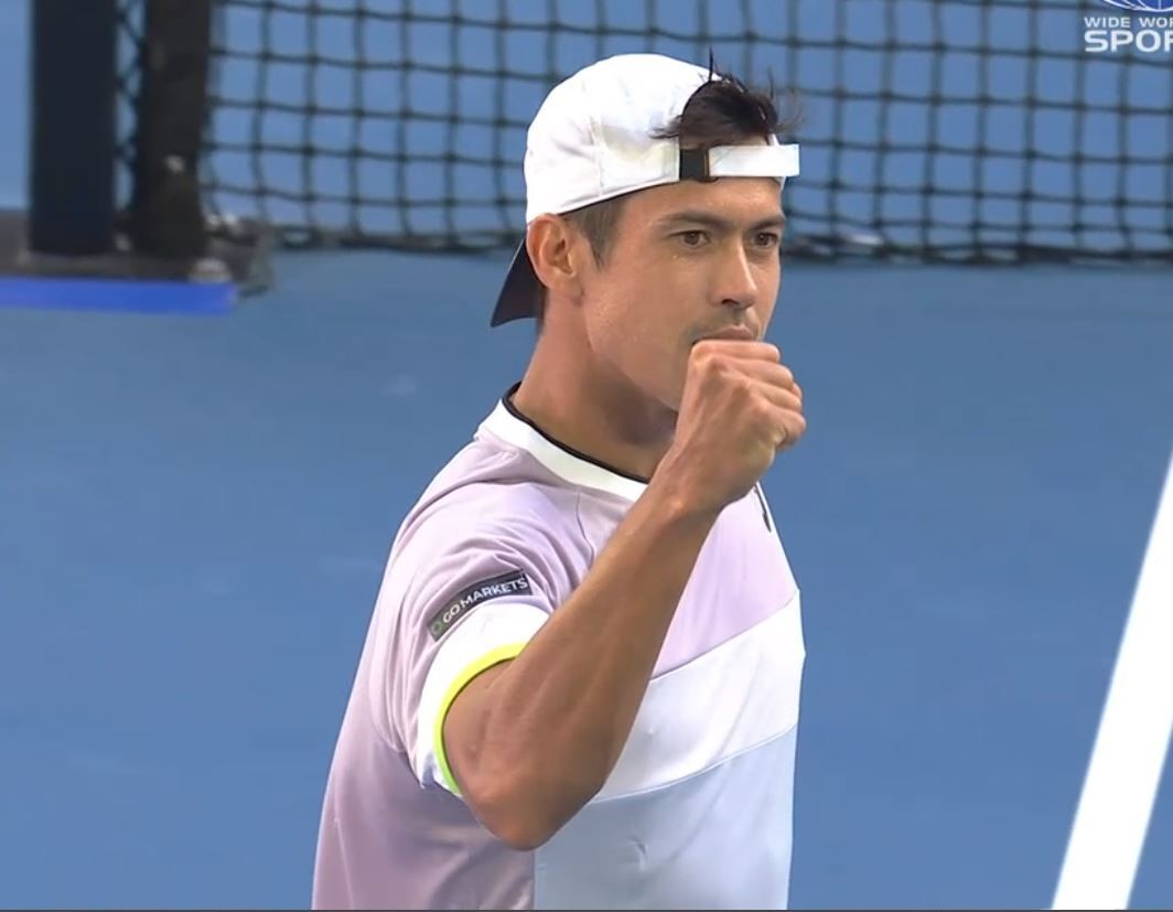 Tennis player pumps his fist.