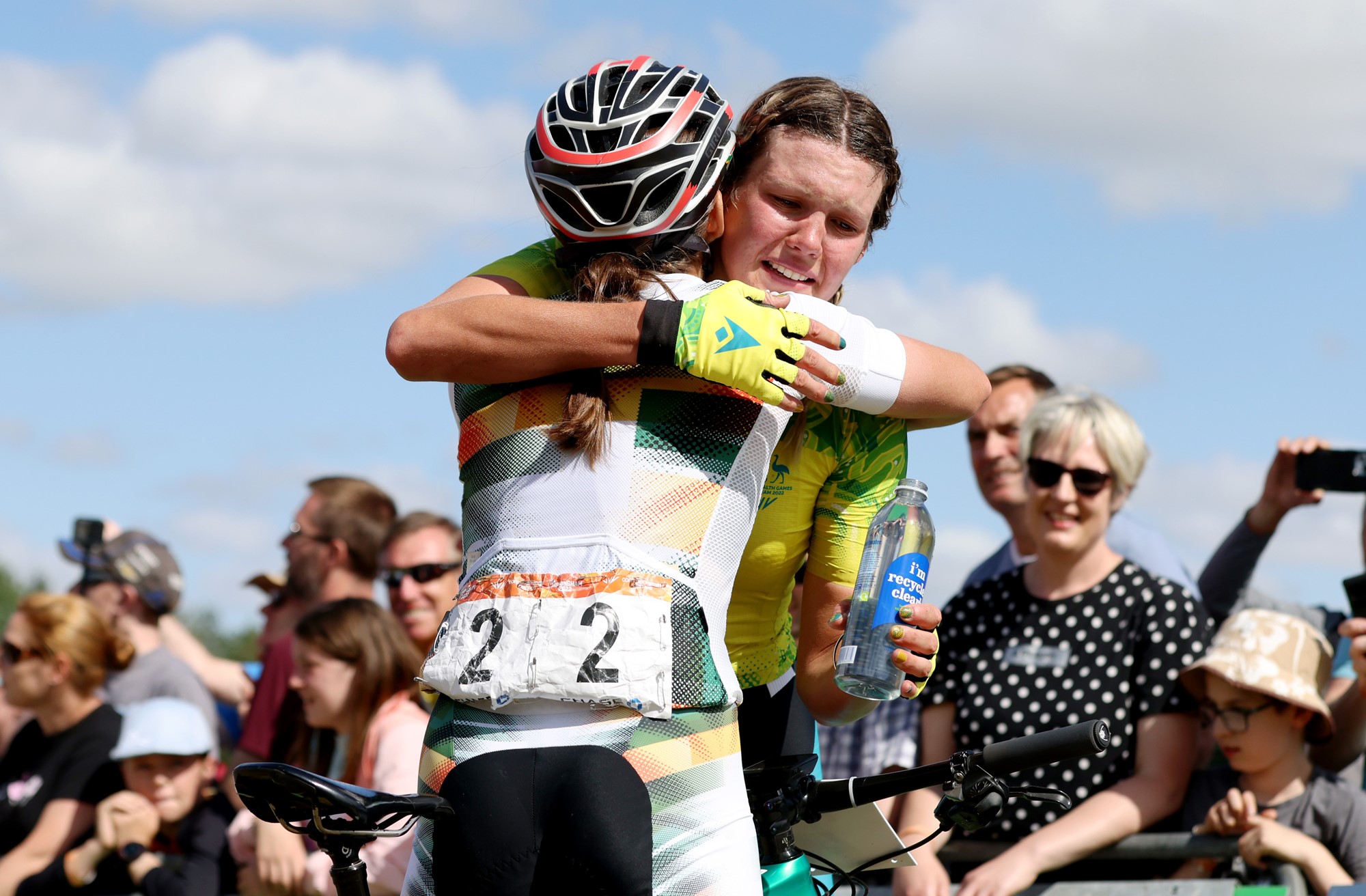 Two cyclists hug after the Commonwealth Games mountain bike race