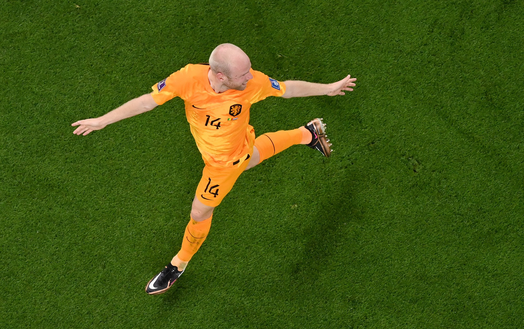 Dutch player viewed from above celebrating with arms spread