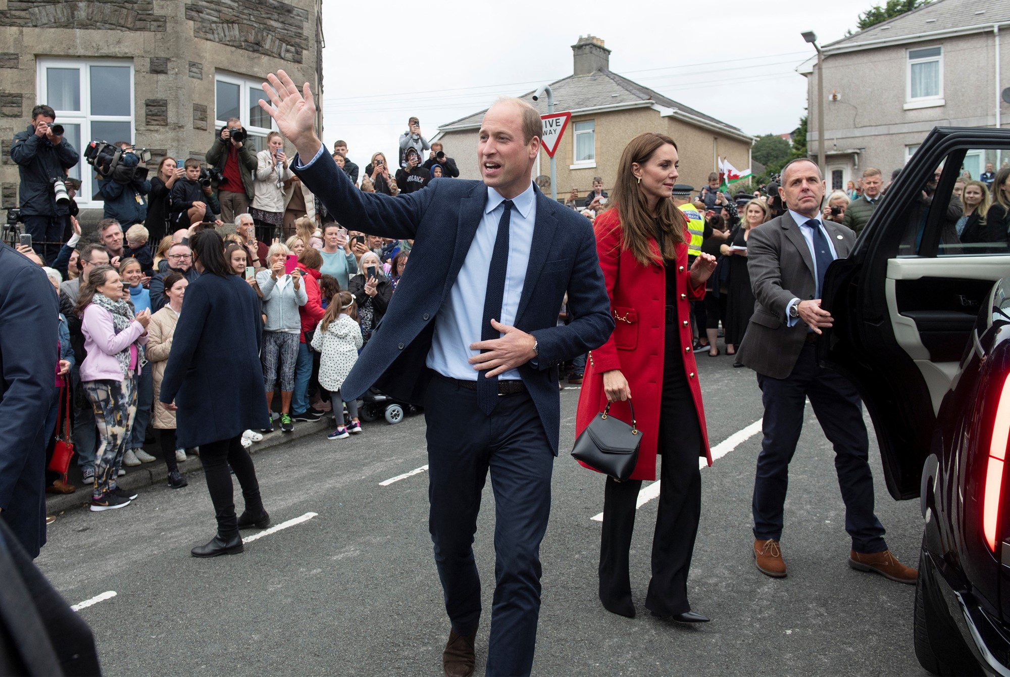 Prince William waves at crowds with Princess Catherine beside him