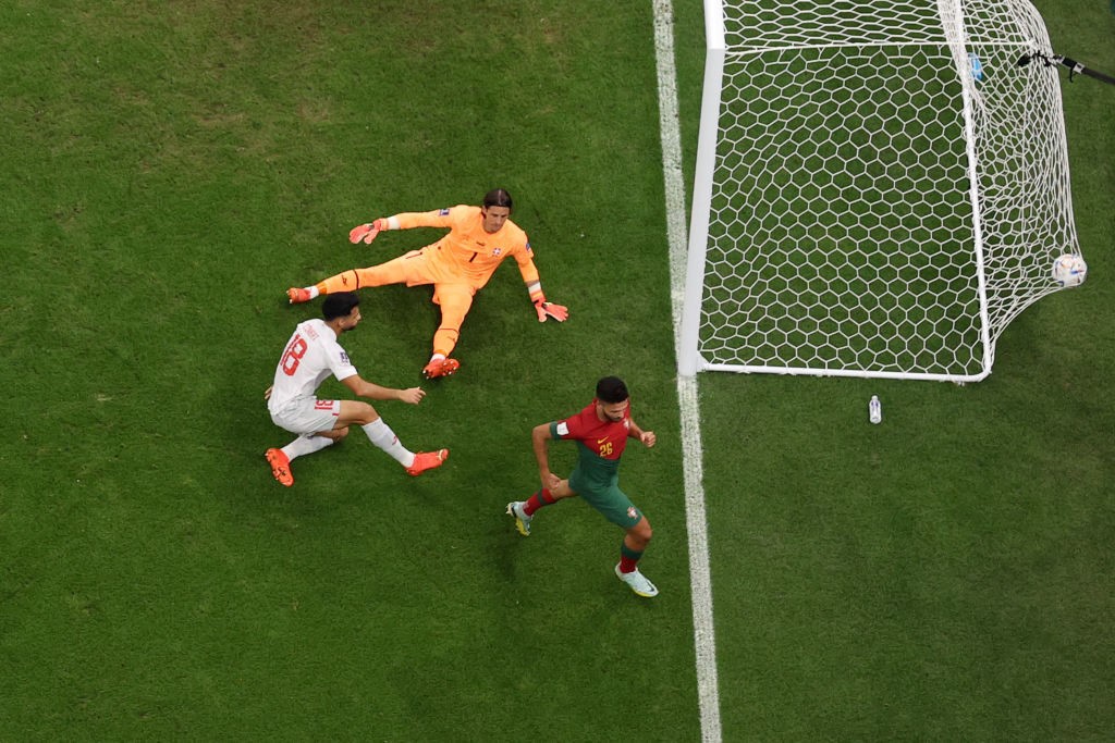 The ball hits the back of the net as Portugal's Goncalo Ramos runs off in celebration during their World Cup match.