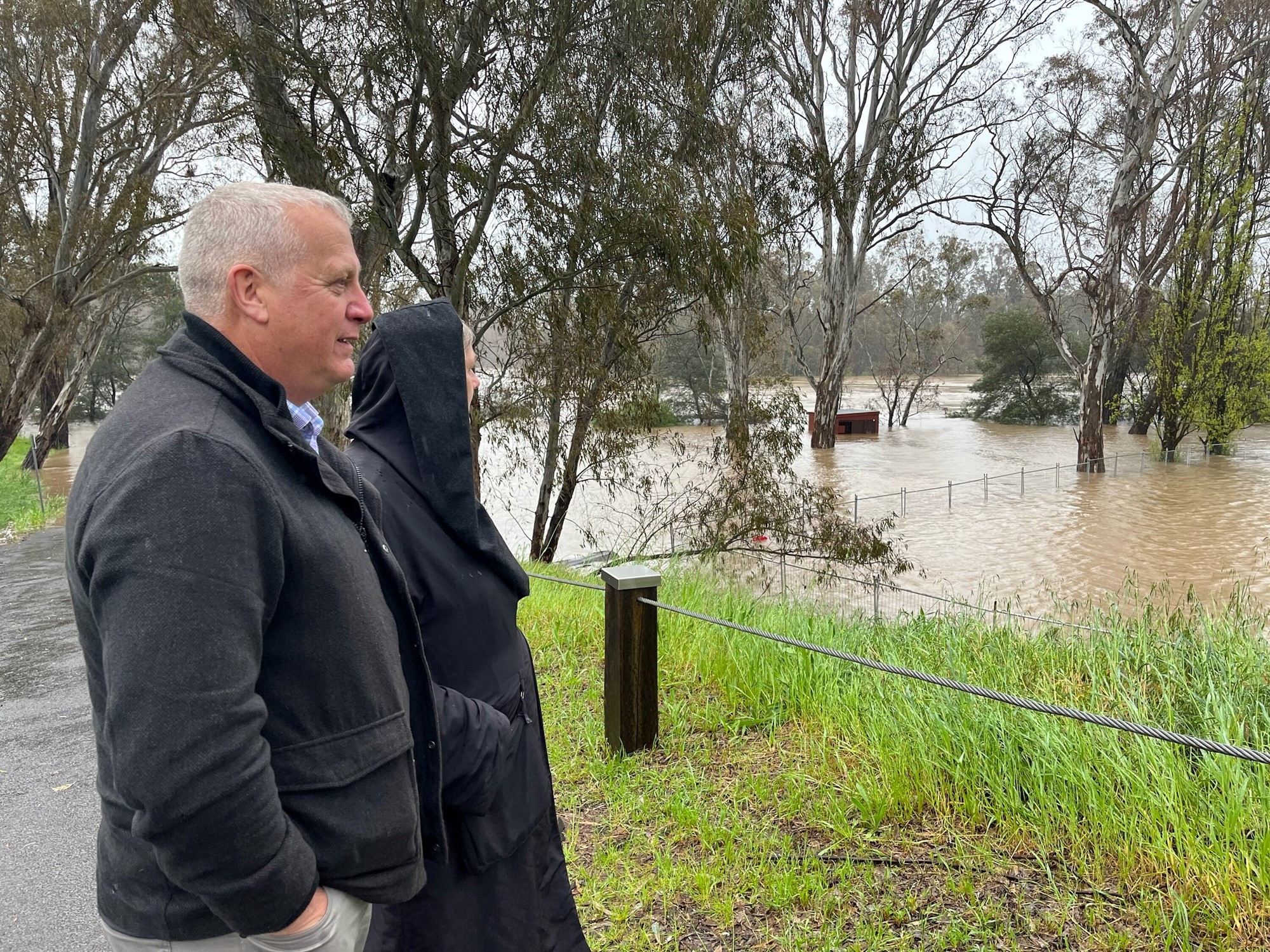 Picture shows Brett and Fiona observing the floodwaters.