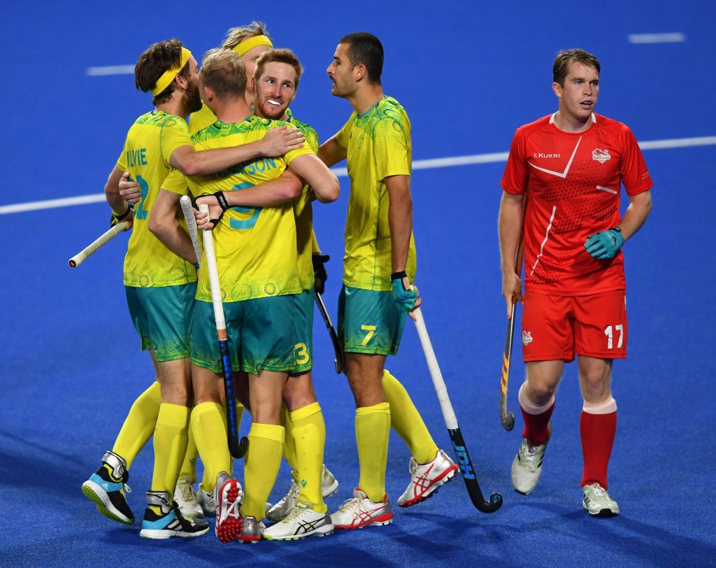 A group of Australians celebrate by hugging