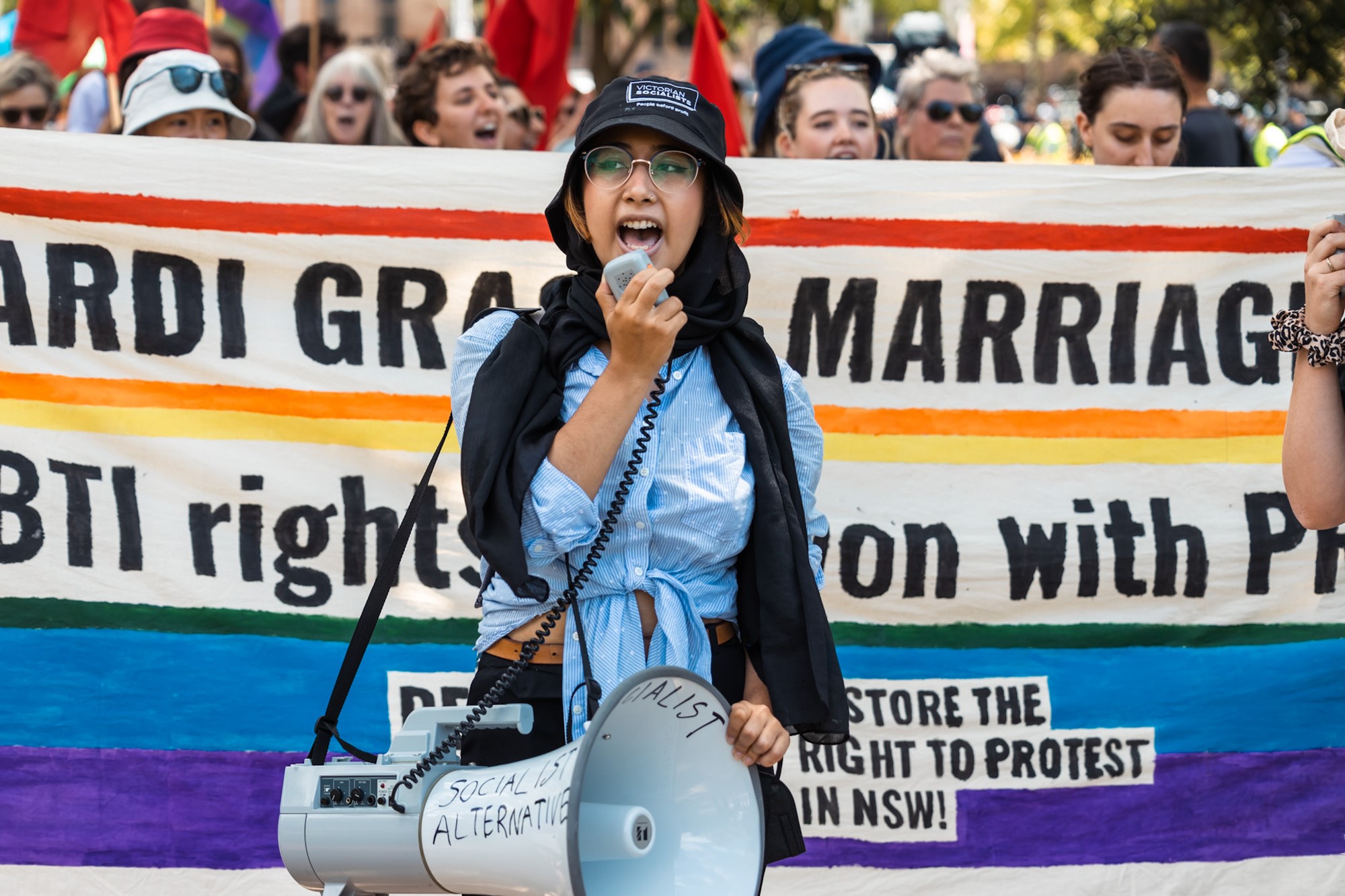 A woman speaks into a megaphone