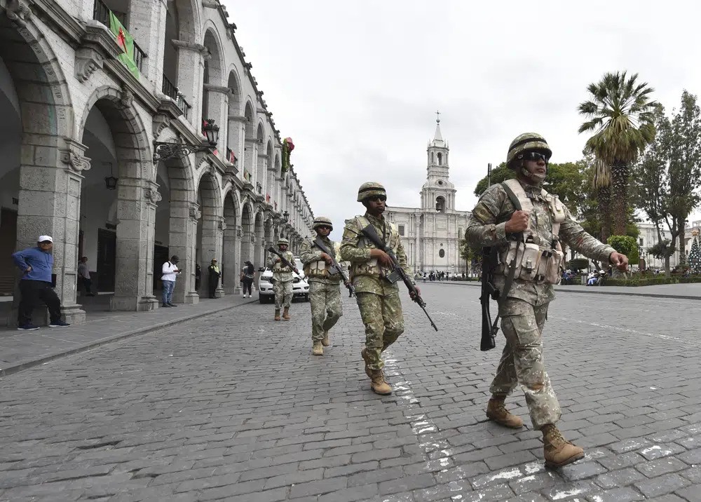 Soldiers patrol the streets of Peru.