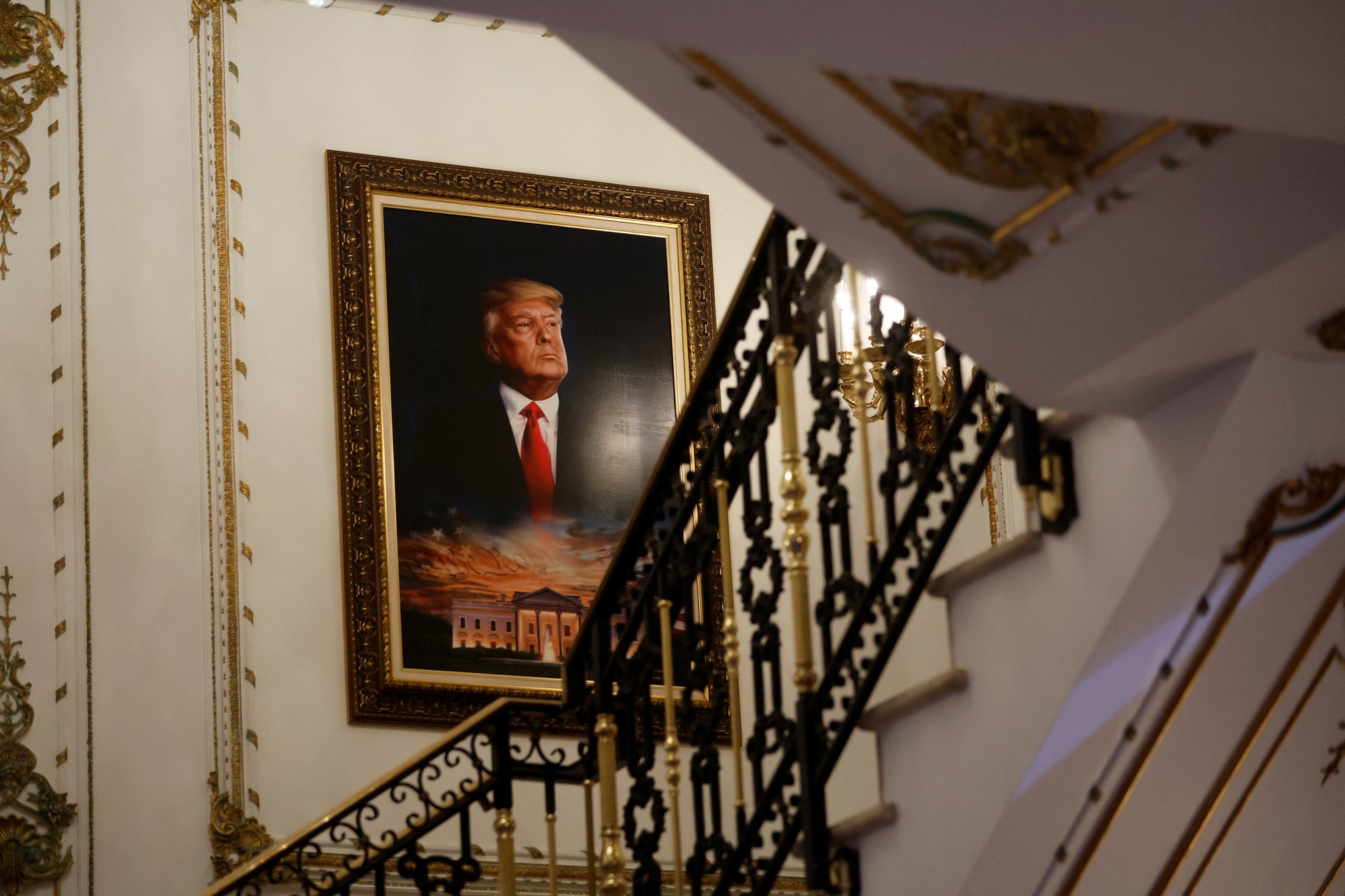 A portrait of Trump hangs on the wall.