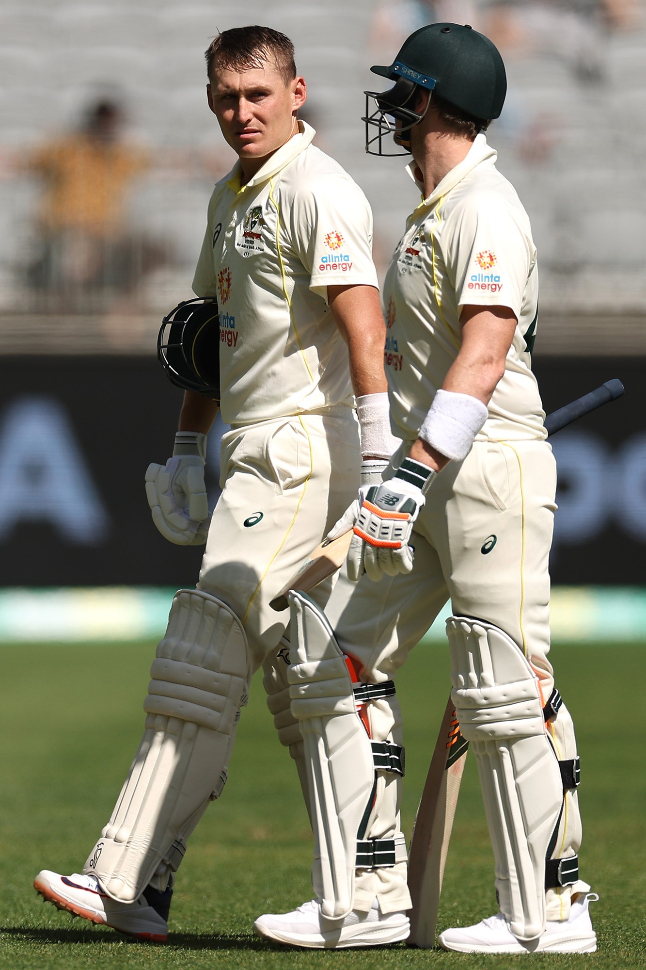 Australia batters Marnus Labuschagne and Steve Smith walk off Perth Stadium on day one of the first Test against West Indies.