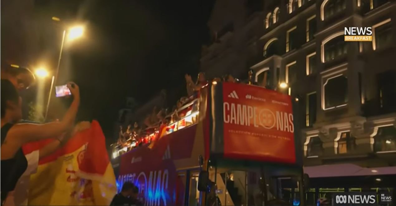 An open top bus riding through street