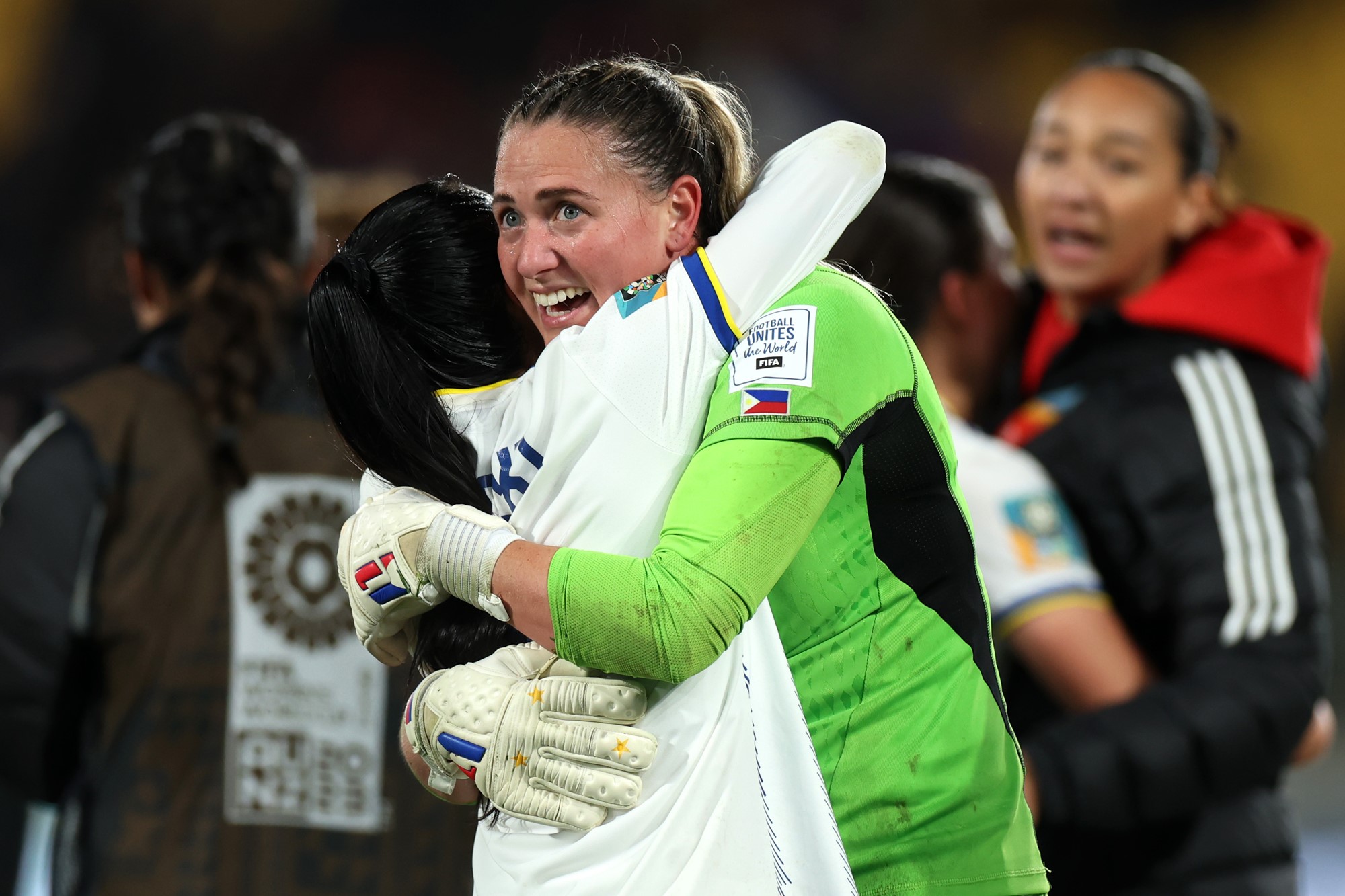 Olivia McDaniel hugs a Philippines teammate after a Women's World Cup win.
