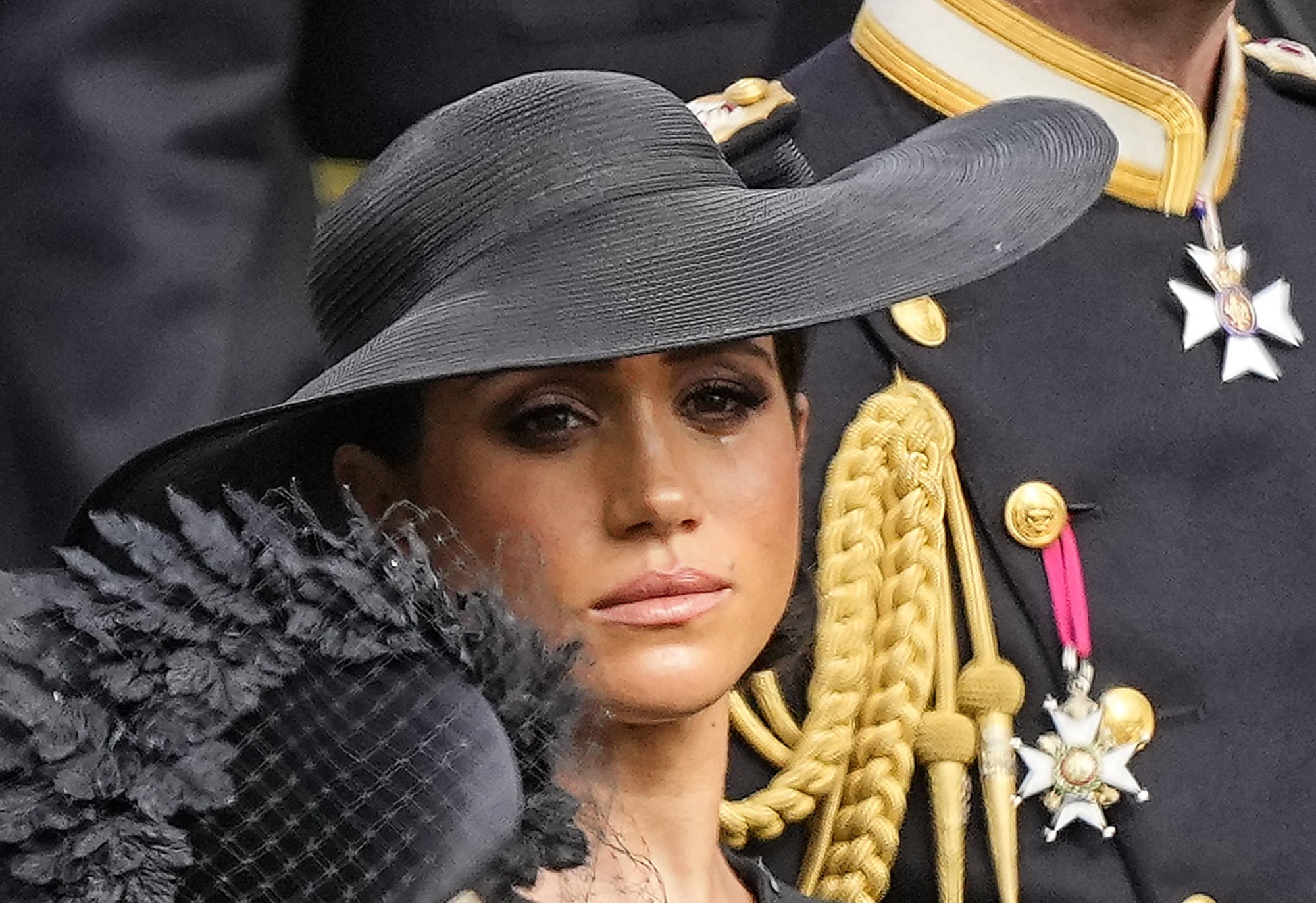Meghan, Duchess of Sussex has a tear drop down her cheek