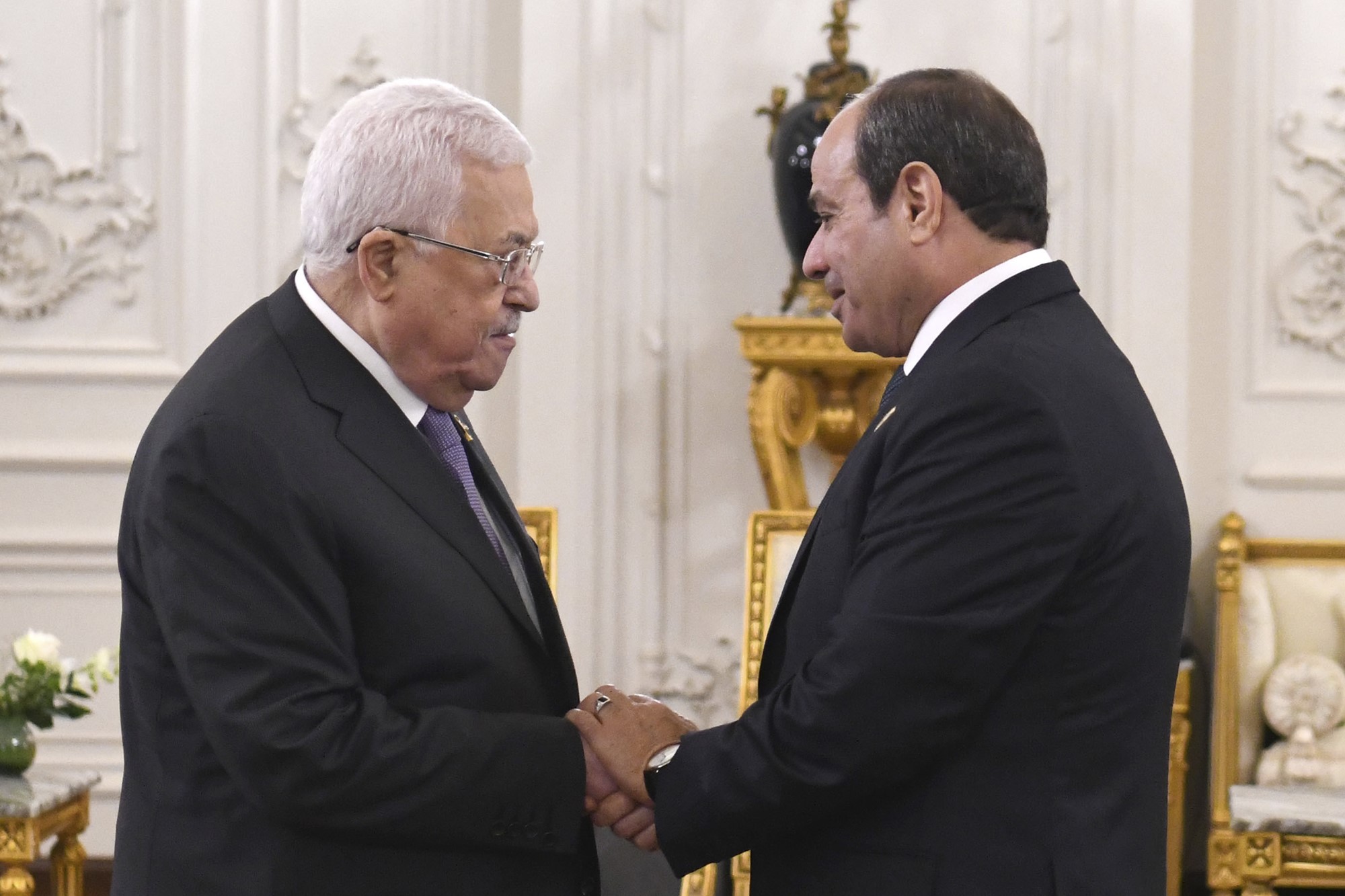 Egyptian President Abdel Fattah el-Sissi, right, greets Palestinian President Mahmoud Abbas.