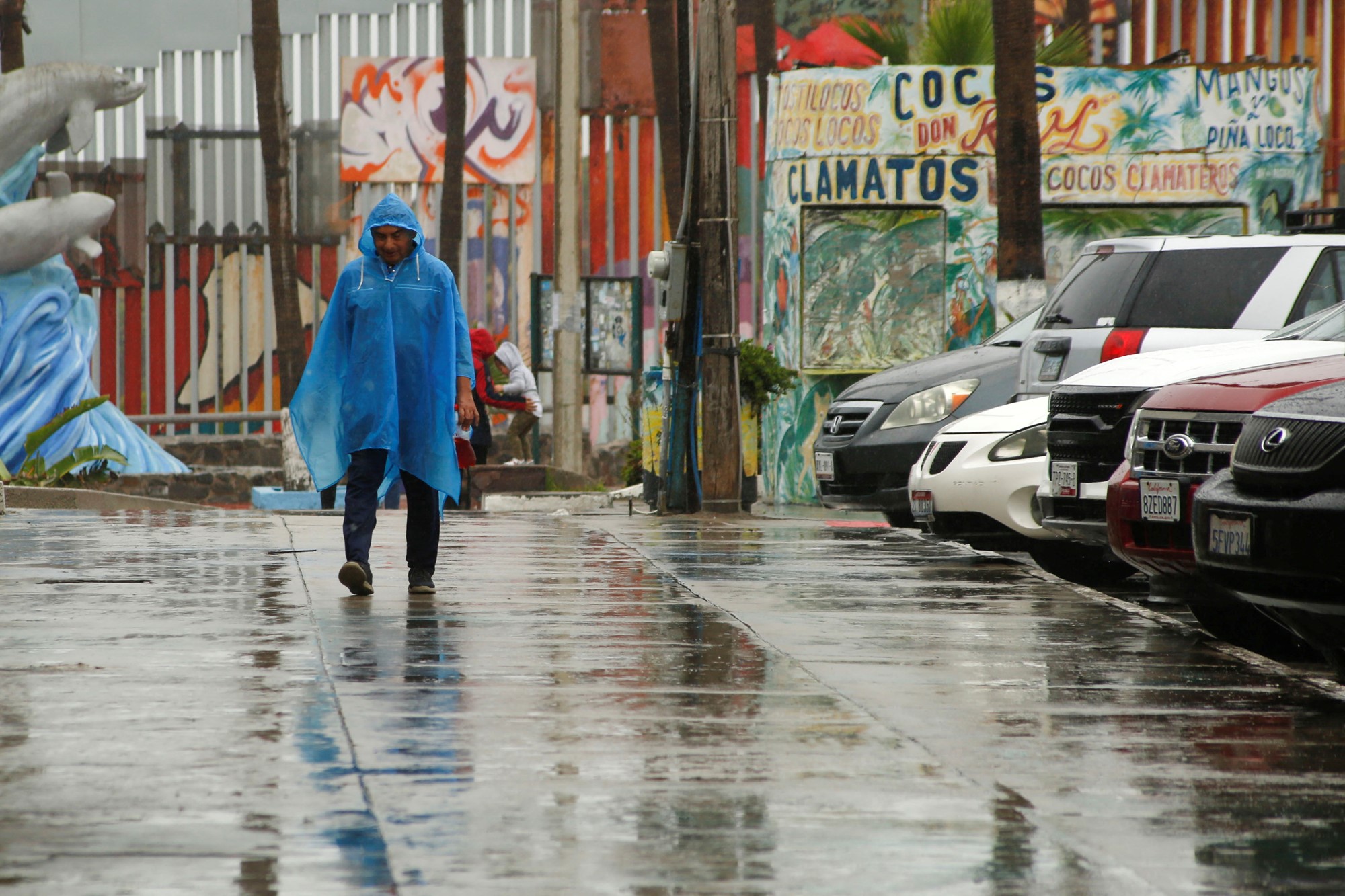 A man walks in a rain poncho in Tijiuana