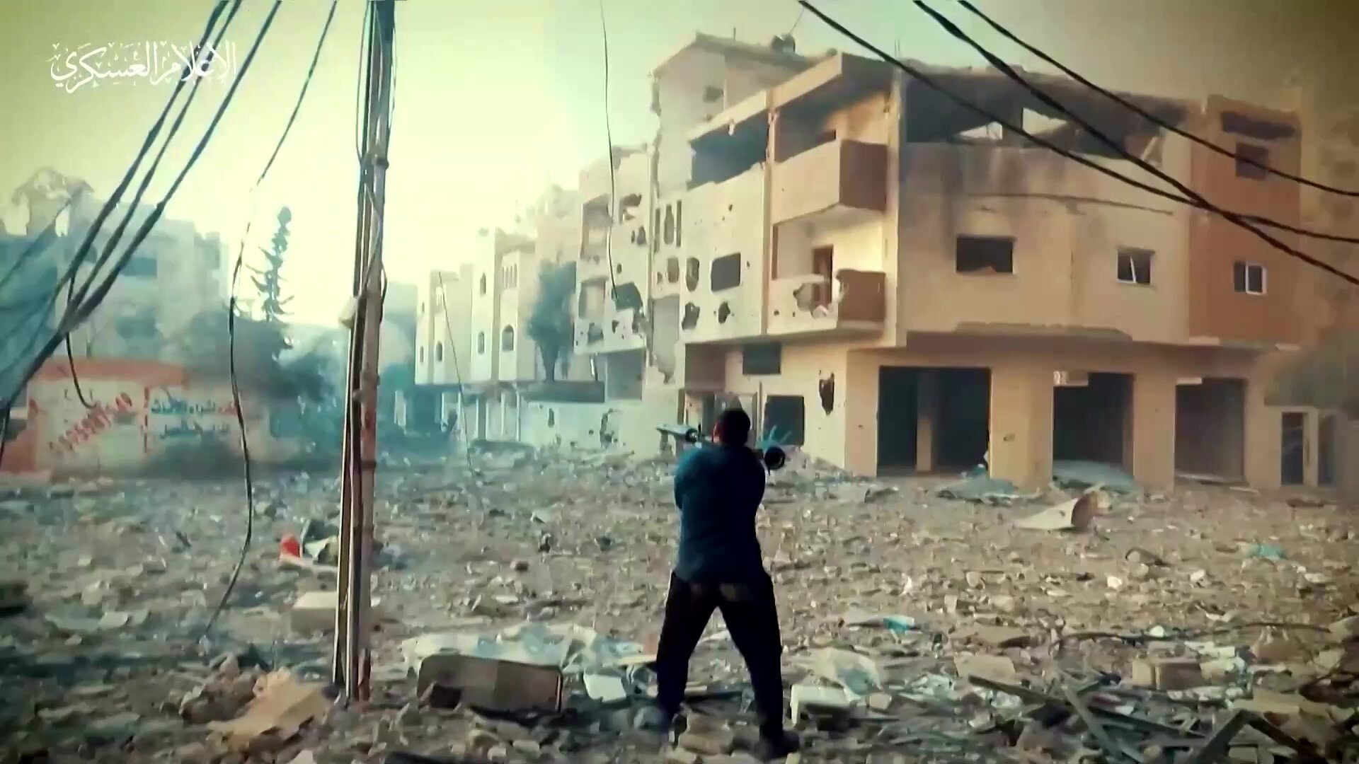 Man using rocket launcher on his shoulder amongst rubble