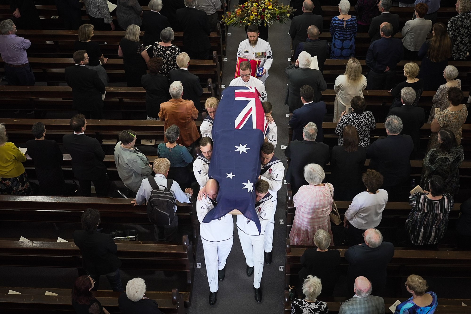 Bill Hayden's coffin leaves a church in Ipswich being carried by soldiers.