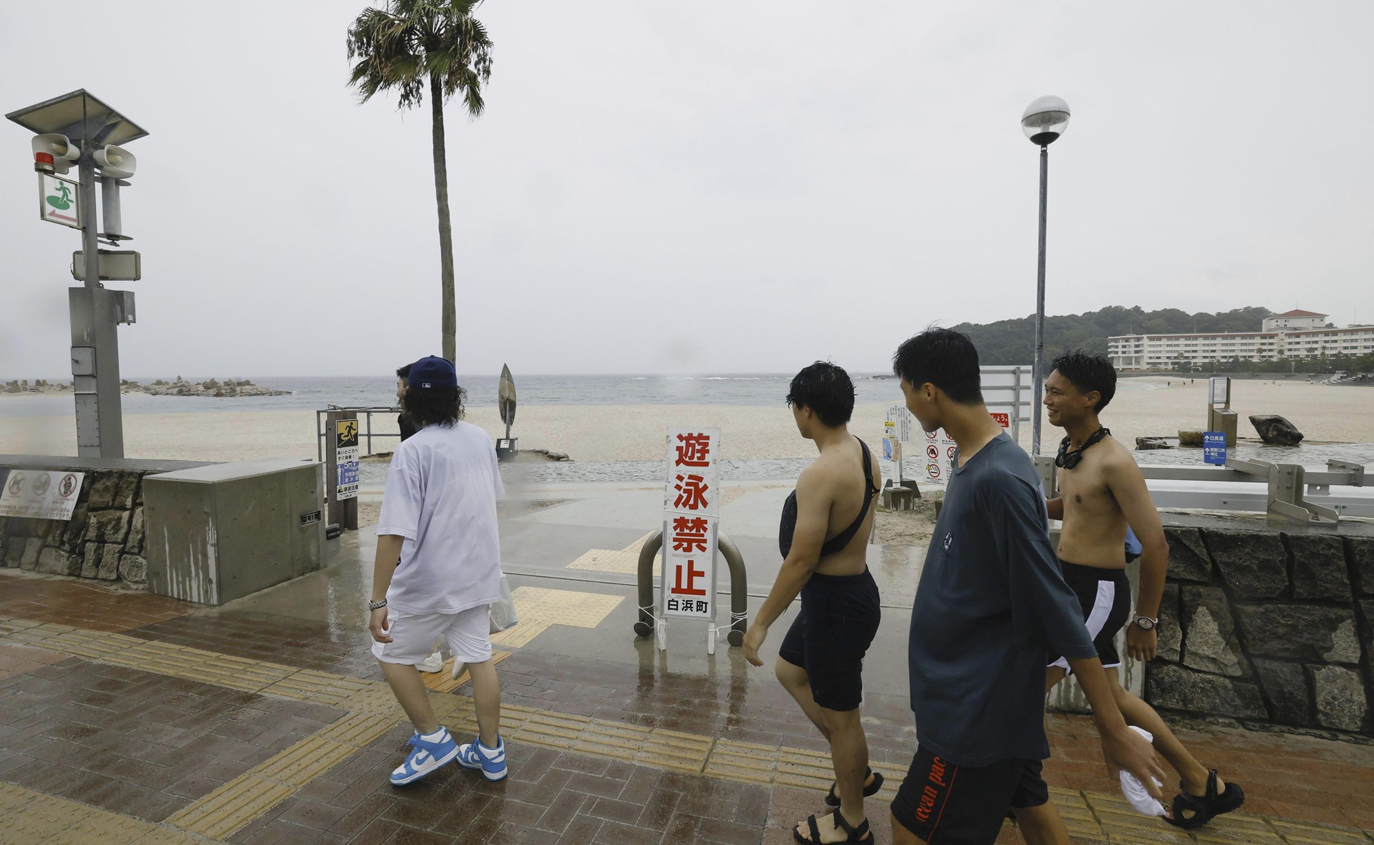 People walk past a swimming beach in Shirahama, Wakayama prefecture, western Japan.
