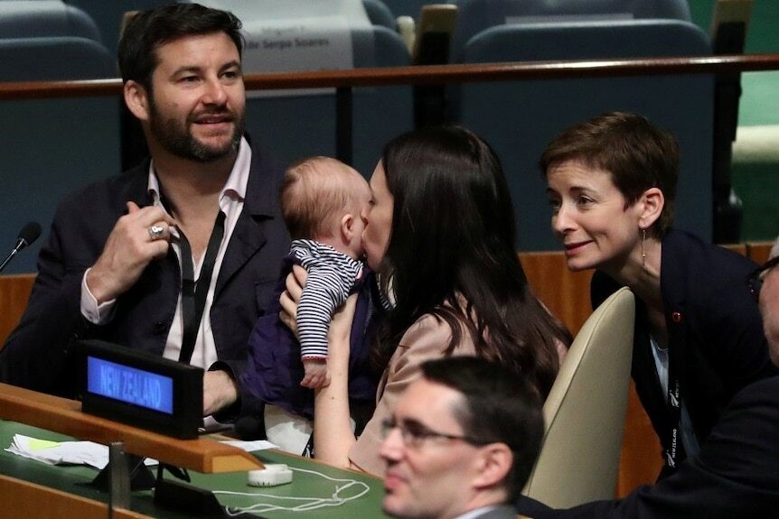 Jacinda kisses her baby on the cheek.