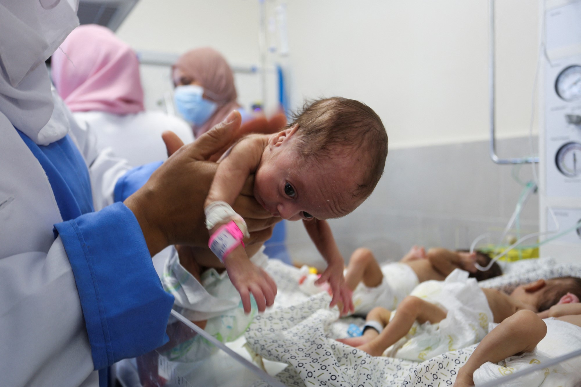 Doctor holds premature baby in his hand 