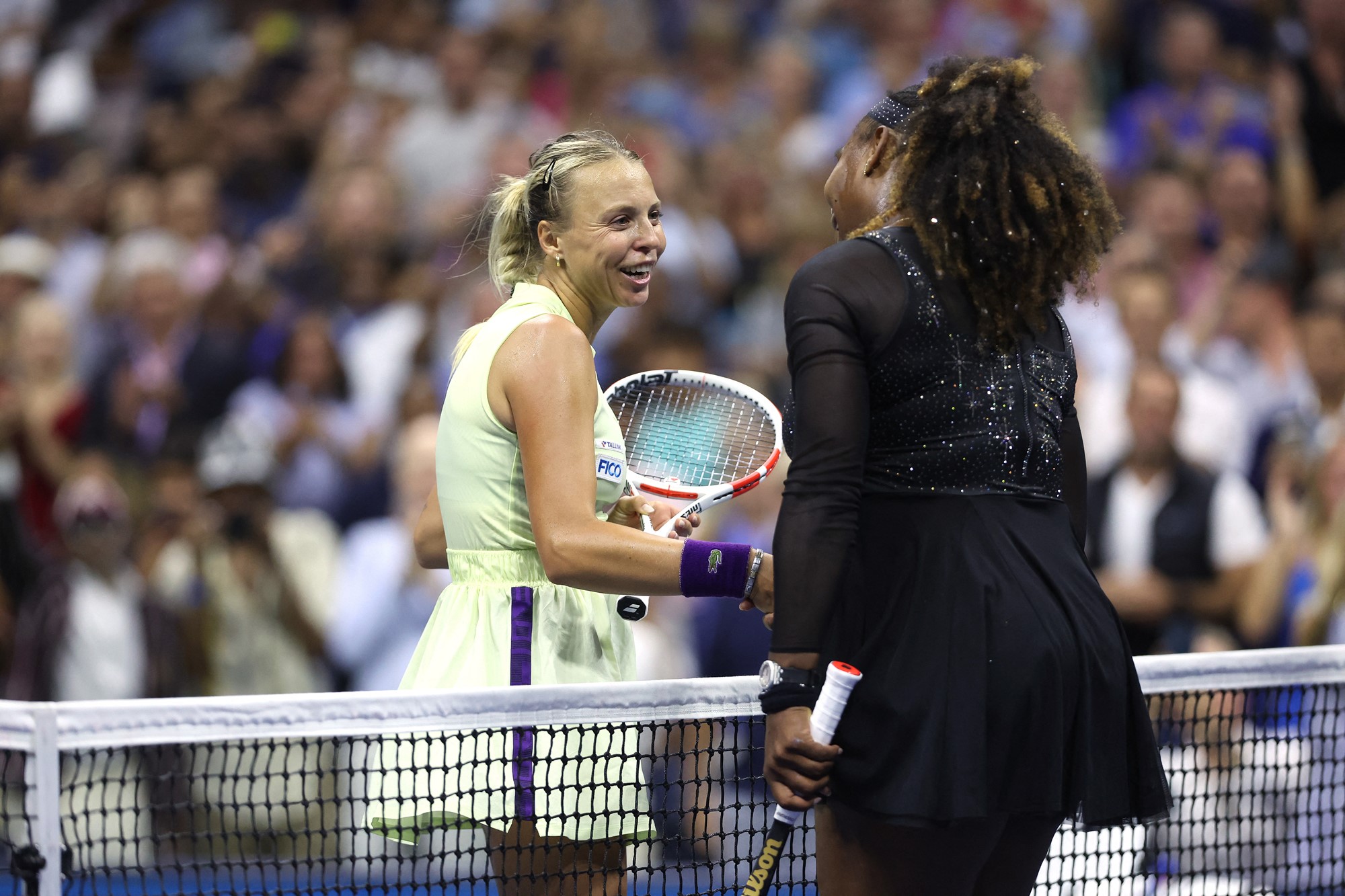 Two women shake hands at the US Open.