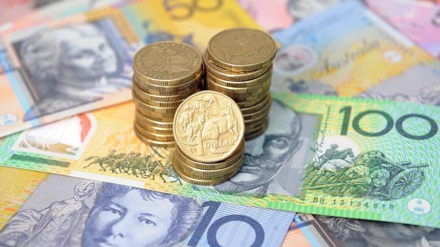 Gold coins stacked on top of Australian notes