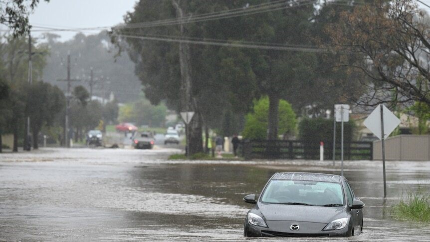 Image shows a car submerged in water.