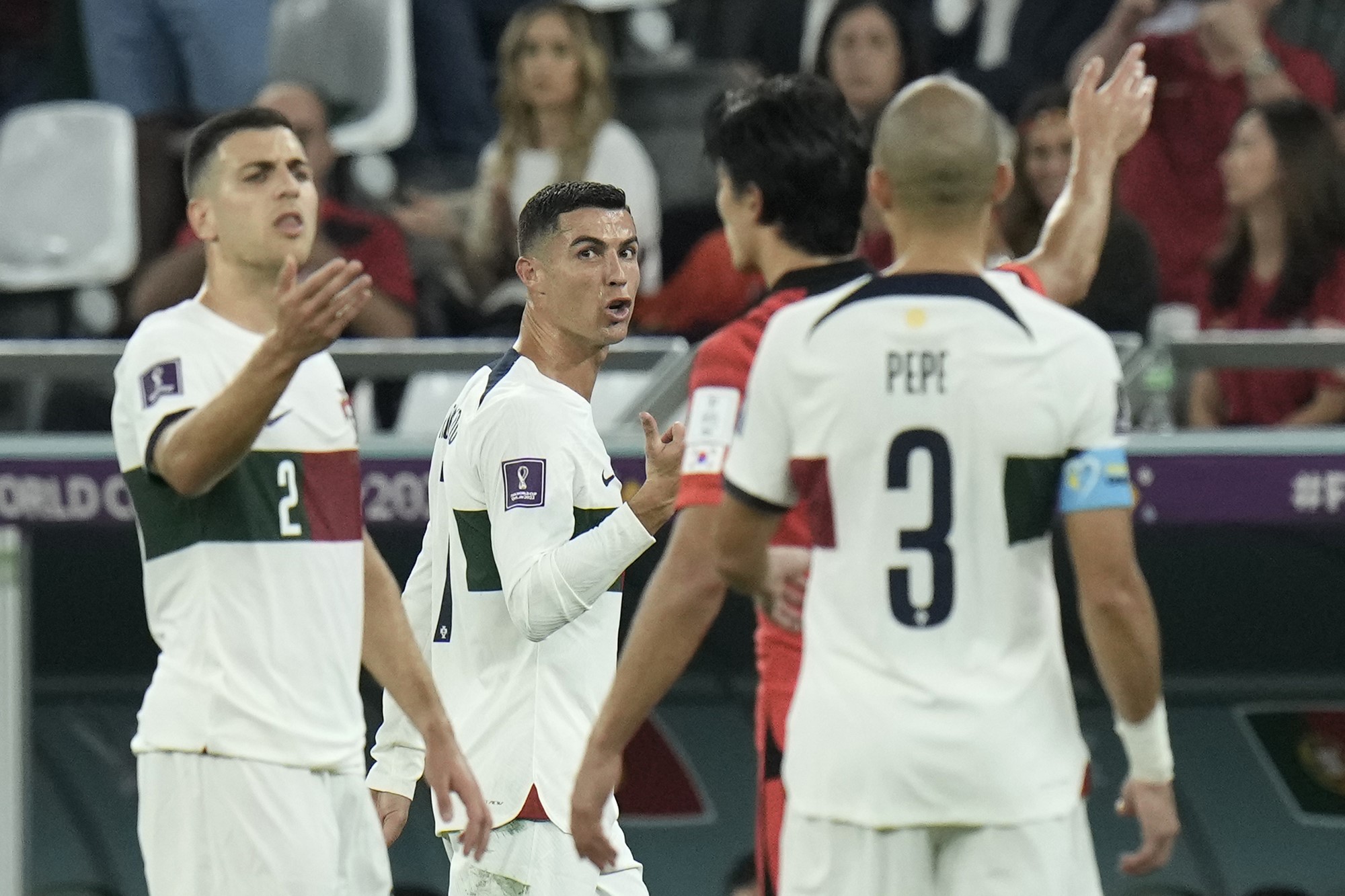 Cristiano Ronaldo and Portugal teammates talk angrily with a South Korean player during their World Cup clash