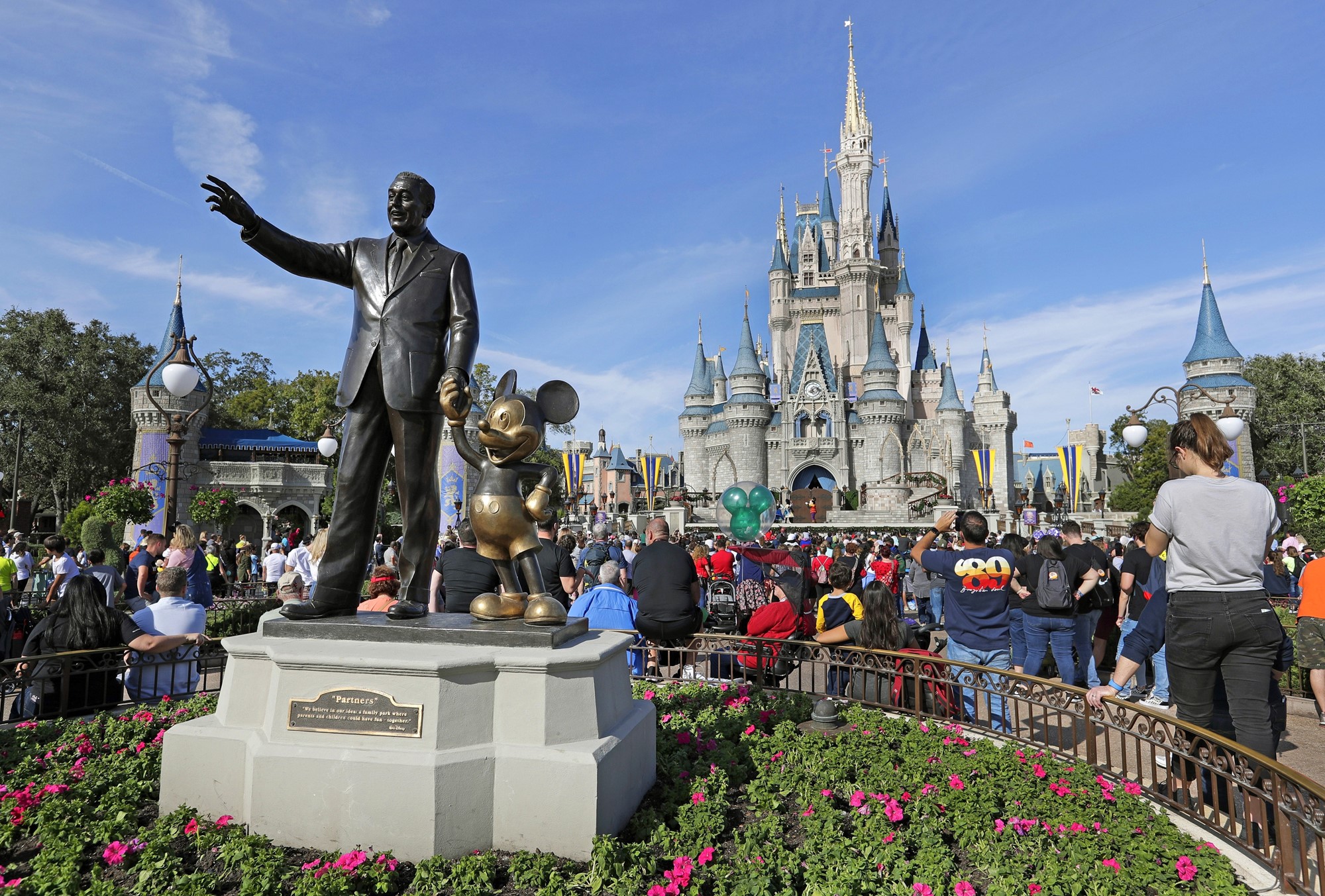 A statue of Walt Disney and Mickey Mouse sits outside Walt Disney World in Florida.