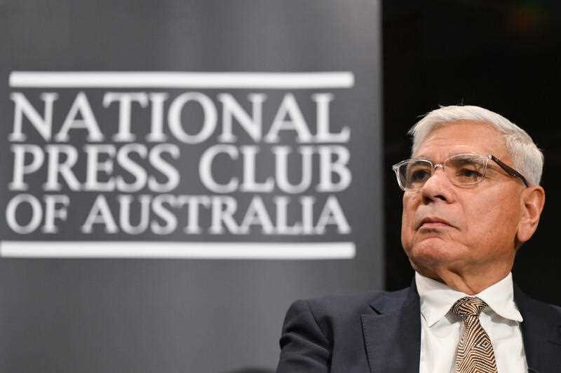 Warren Mundine sits in front of a sigh which says National Press Club of Australia.