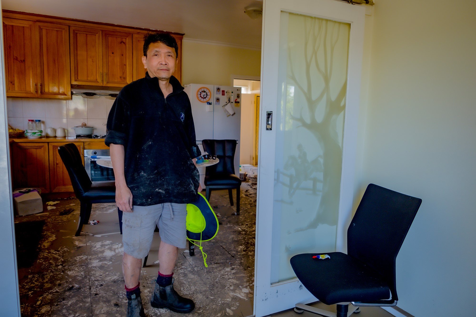 A man standing in a flooded house