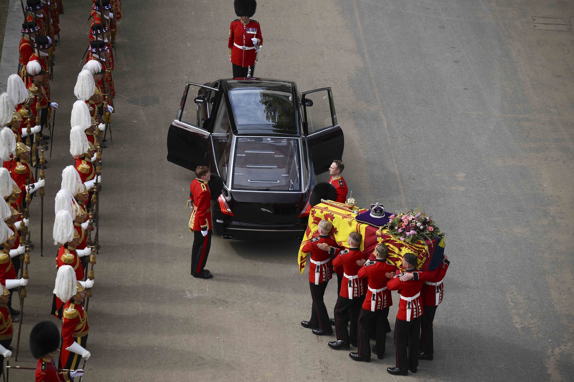 Pallbearers carry the Queen's coffin to a car