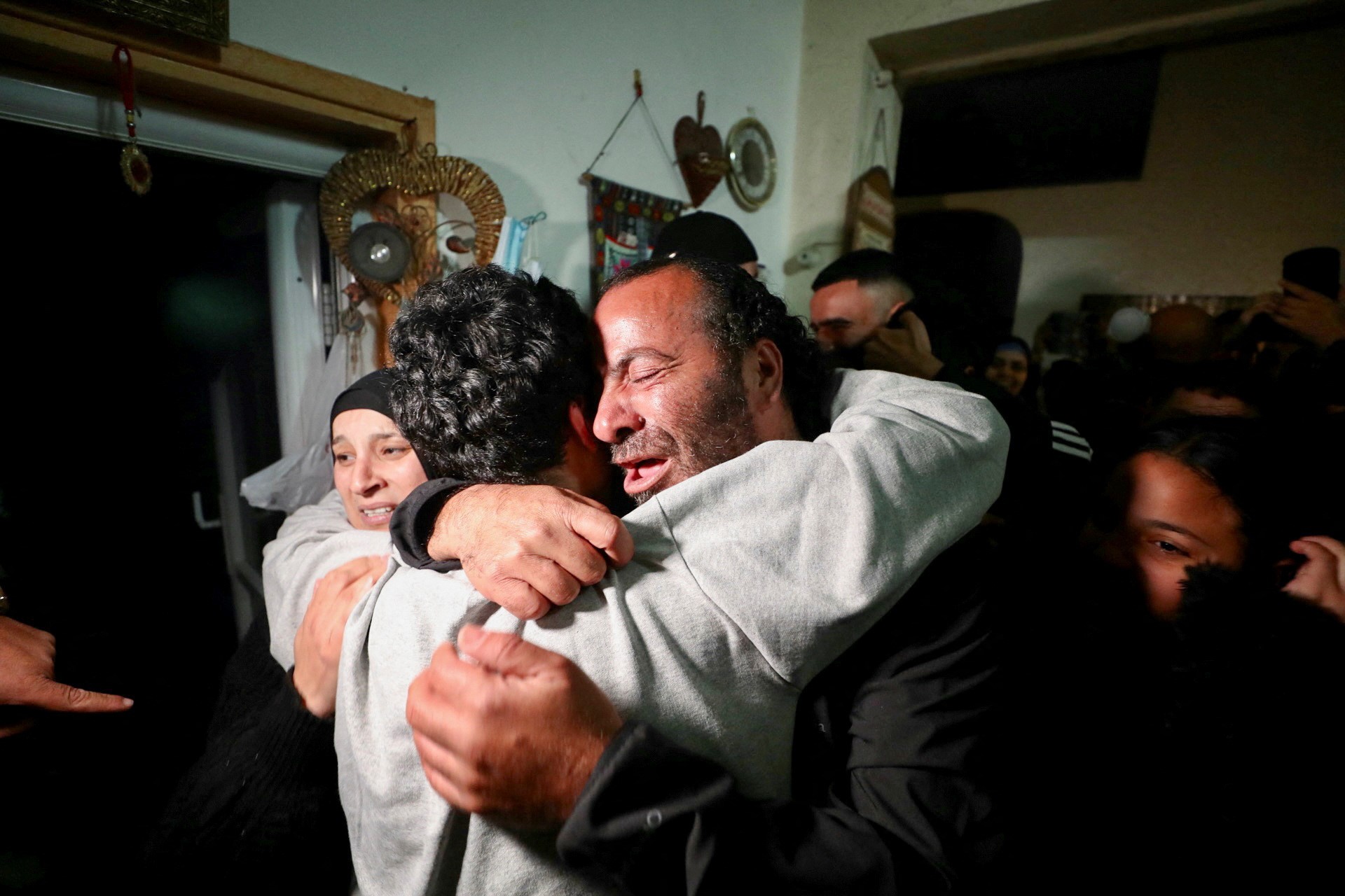 A released Palestinian prisoner embraces a relative as he is received by his family in his house in Jerusalem