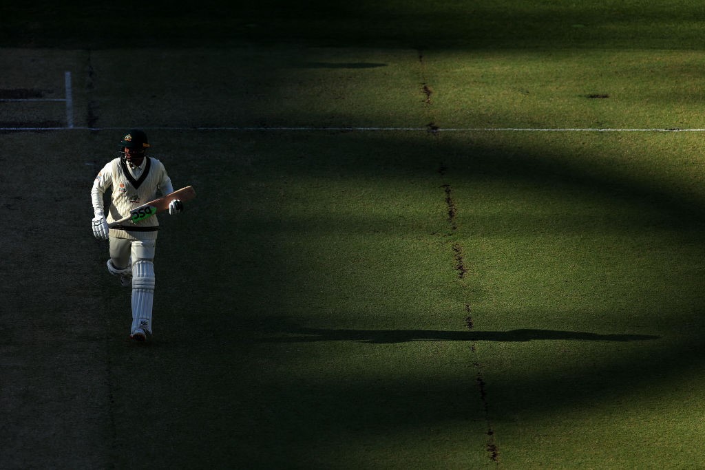 Australia batter Usman Khawaja runs in the long shadows during a Test at Perth Stadium