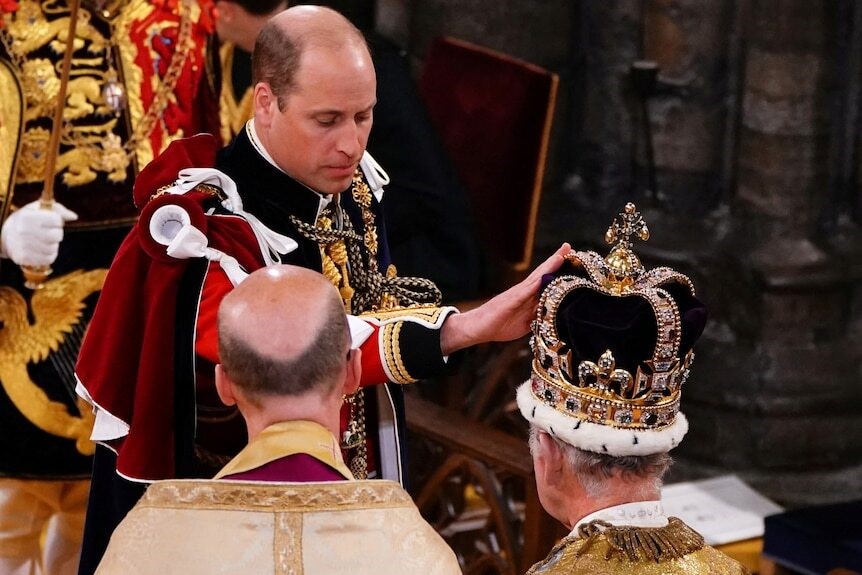 William touches the King's crown.