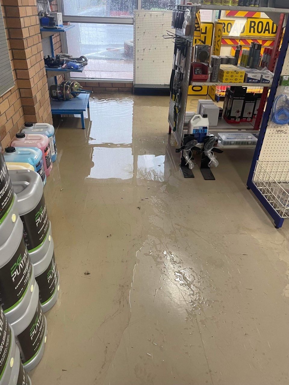 Water covers part of a shop floor.