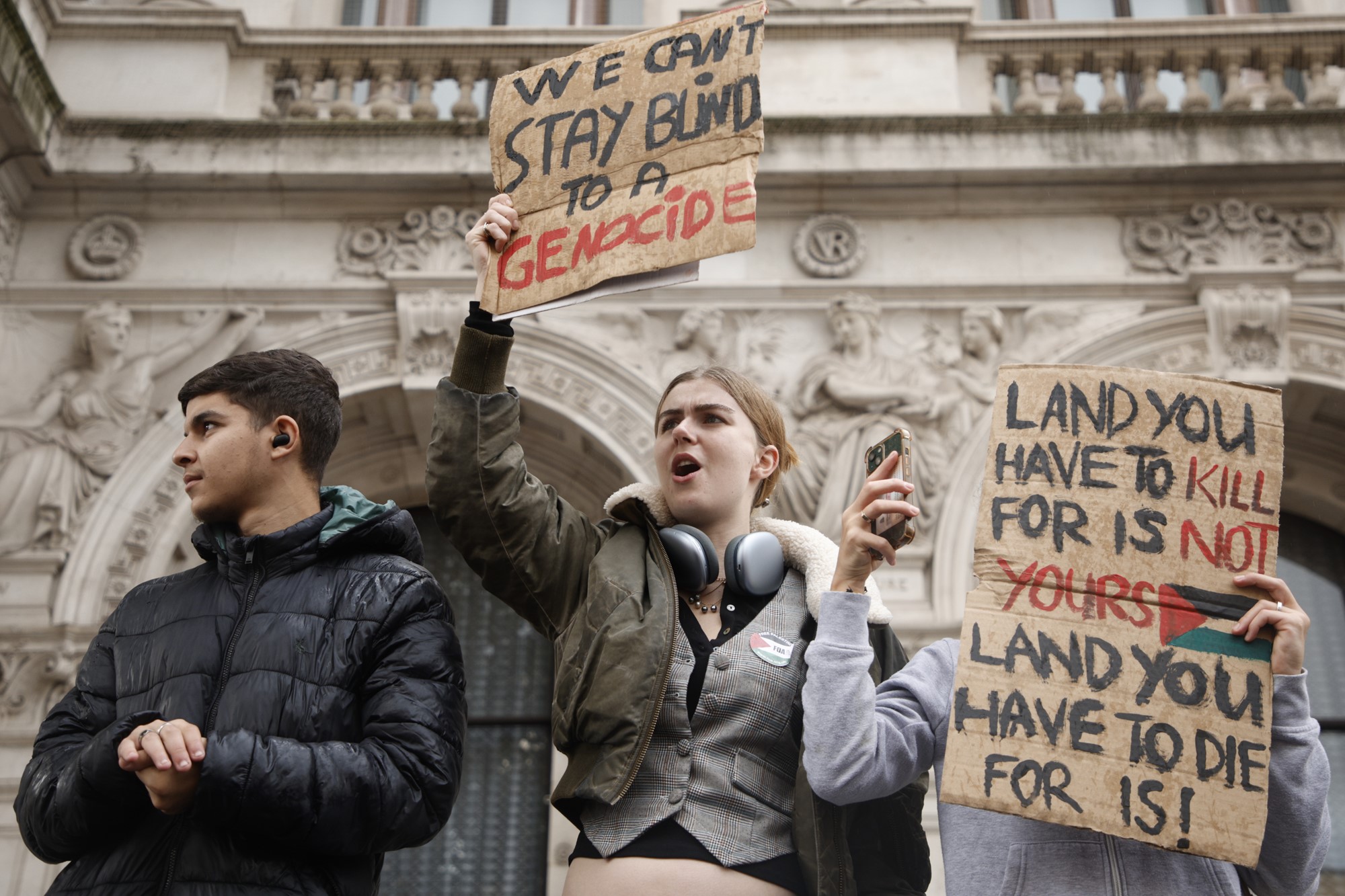 Demonstrators hold up flags and placards during a pro Palestinian demonstration in London