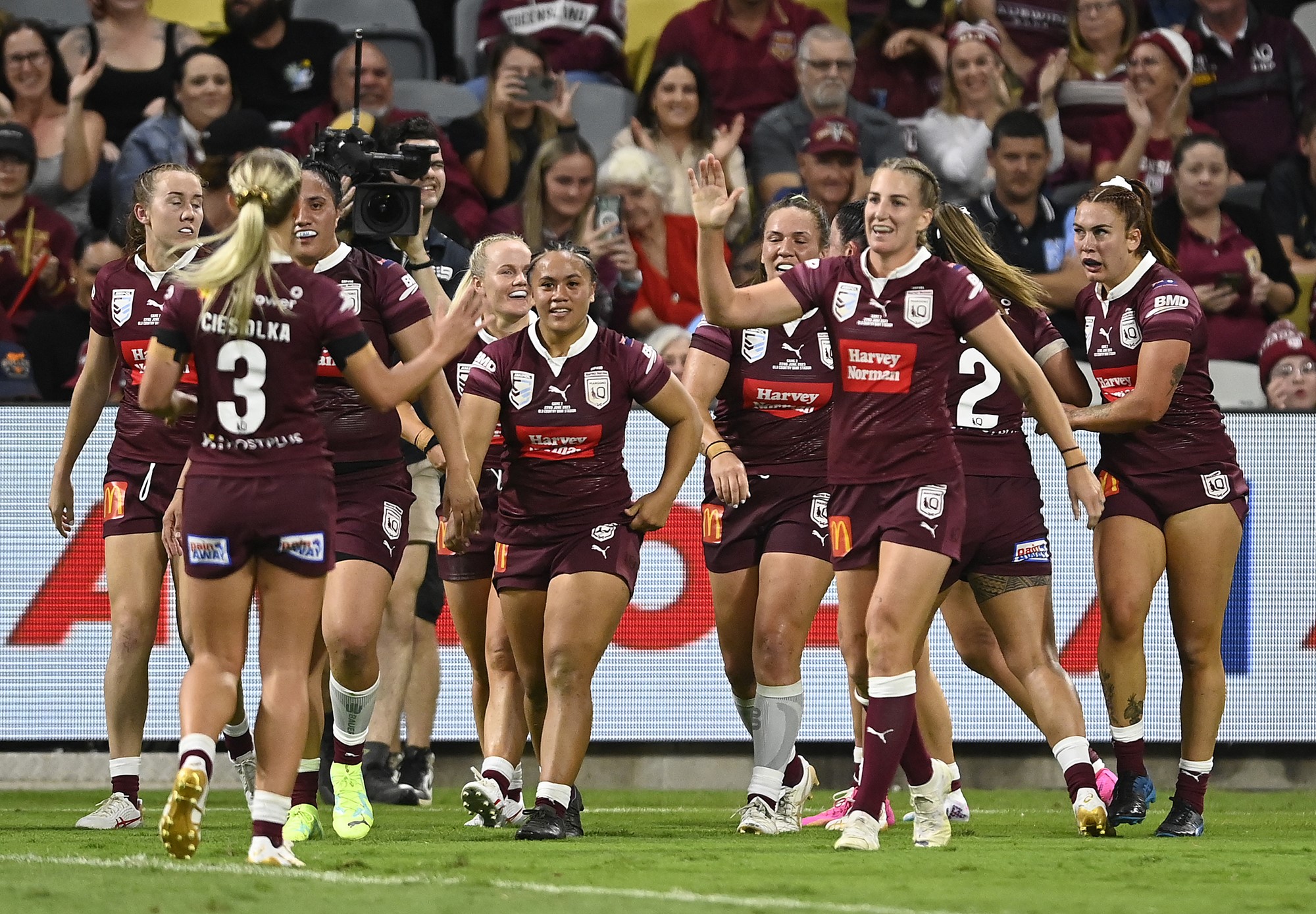 Maroons players celebrate a try in the Women's State of Origin.