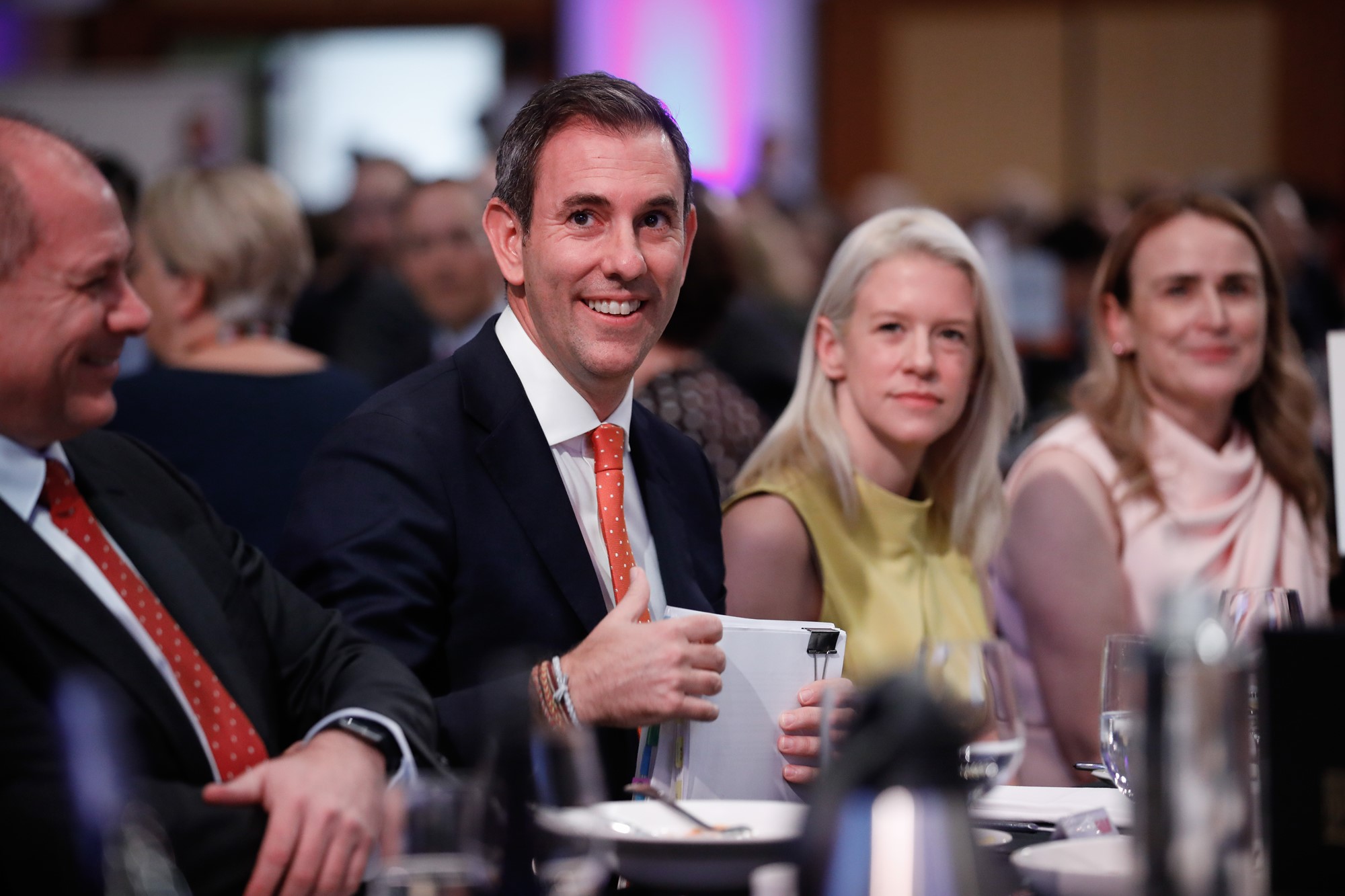 Jim Chalmers smiles at a table.