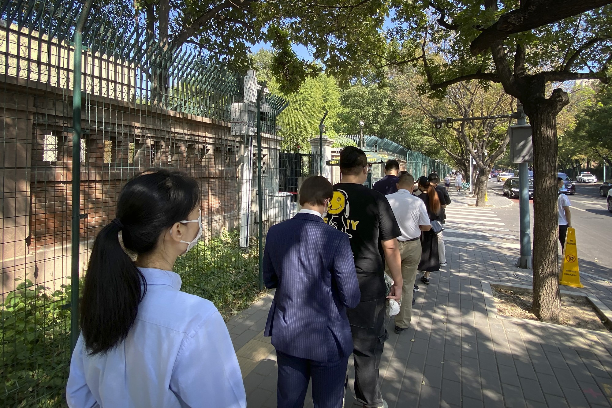 A queue of people along a street in Beijing