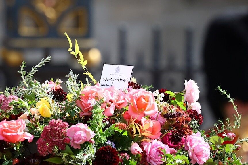 A bouquet of flowers with a note on top