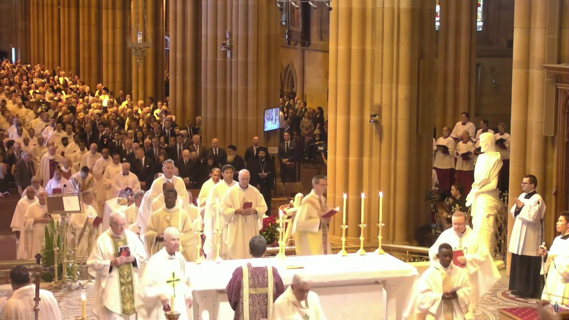 Clergymen walk to the front of the church